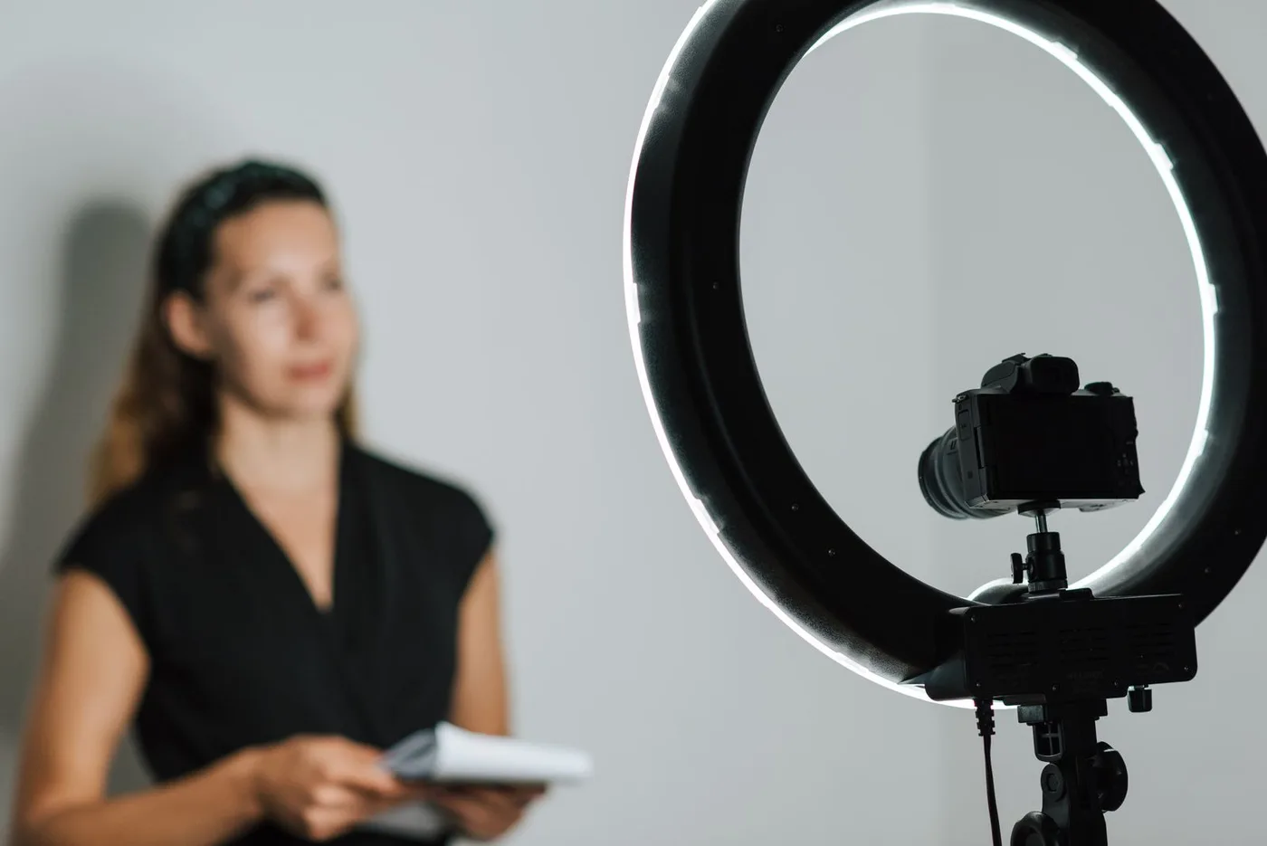 Creator recording a video with a camera and ring light